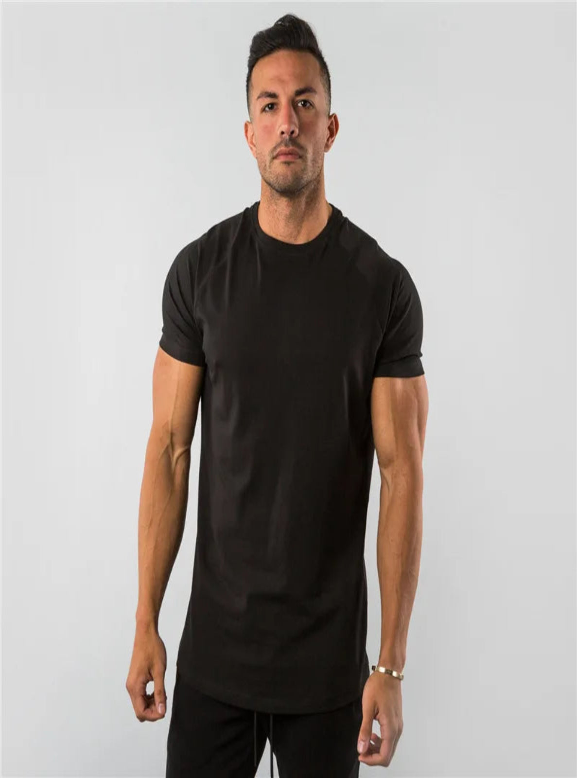 Man wearing a black t-shirt against a plain background
