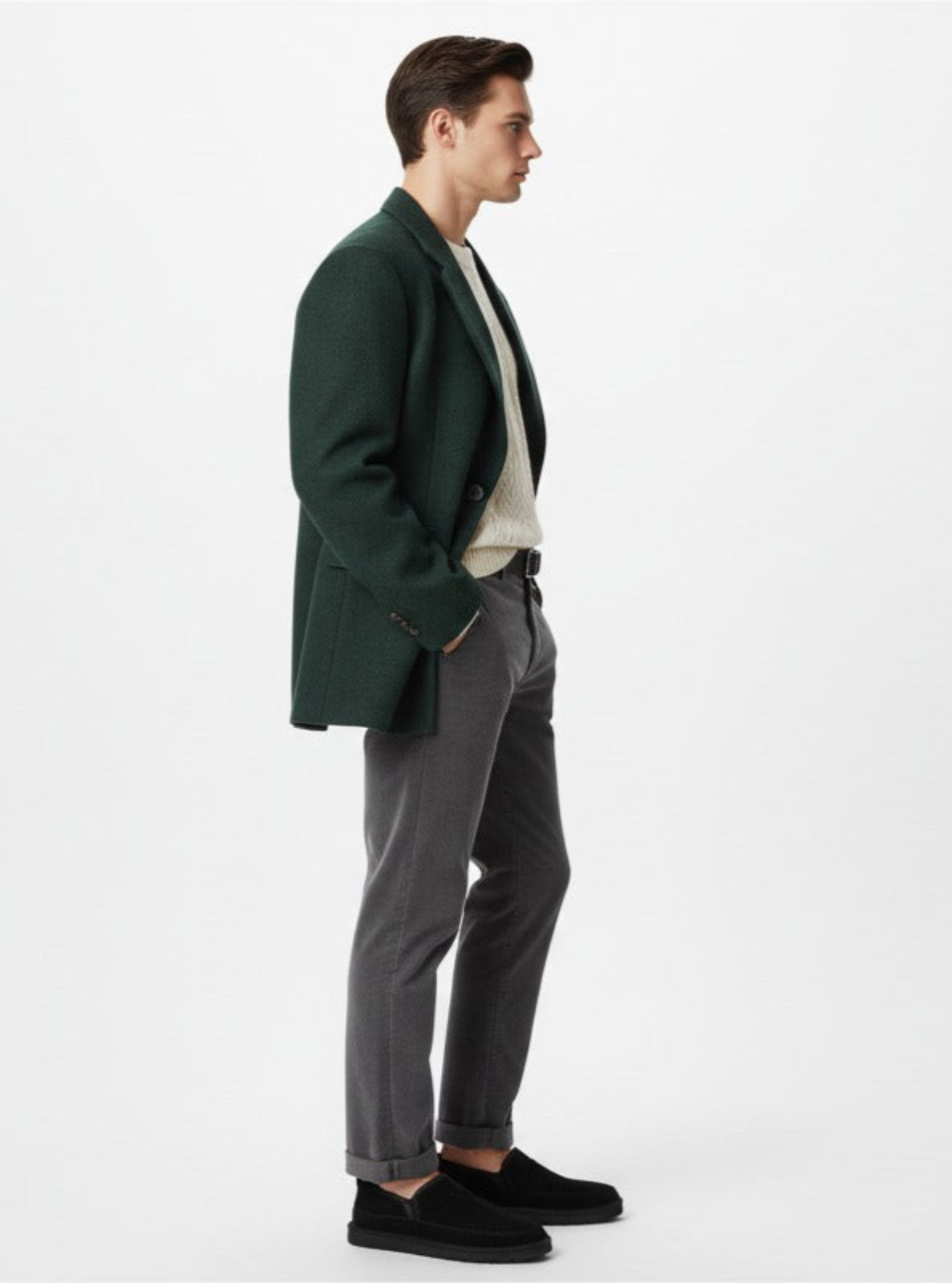Man wearing a green blazer, white shirt, and gray pants on a white background