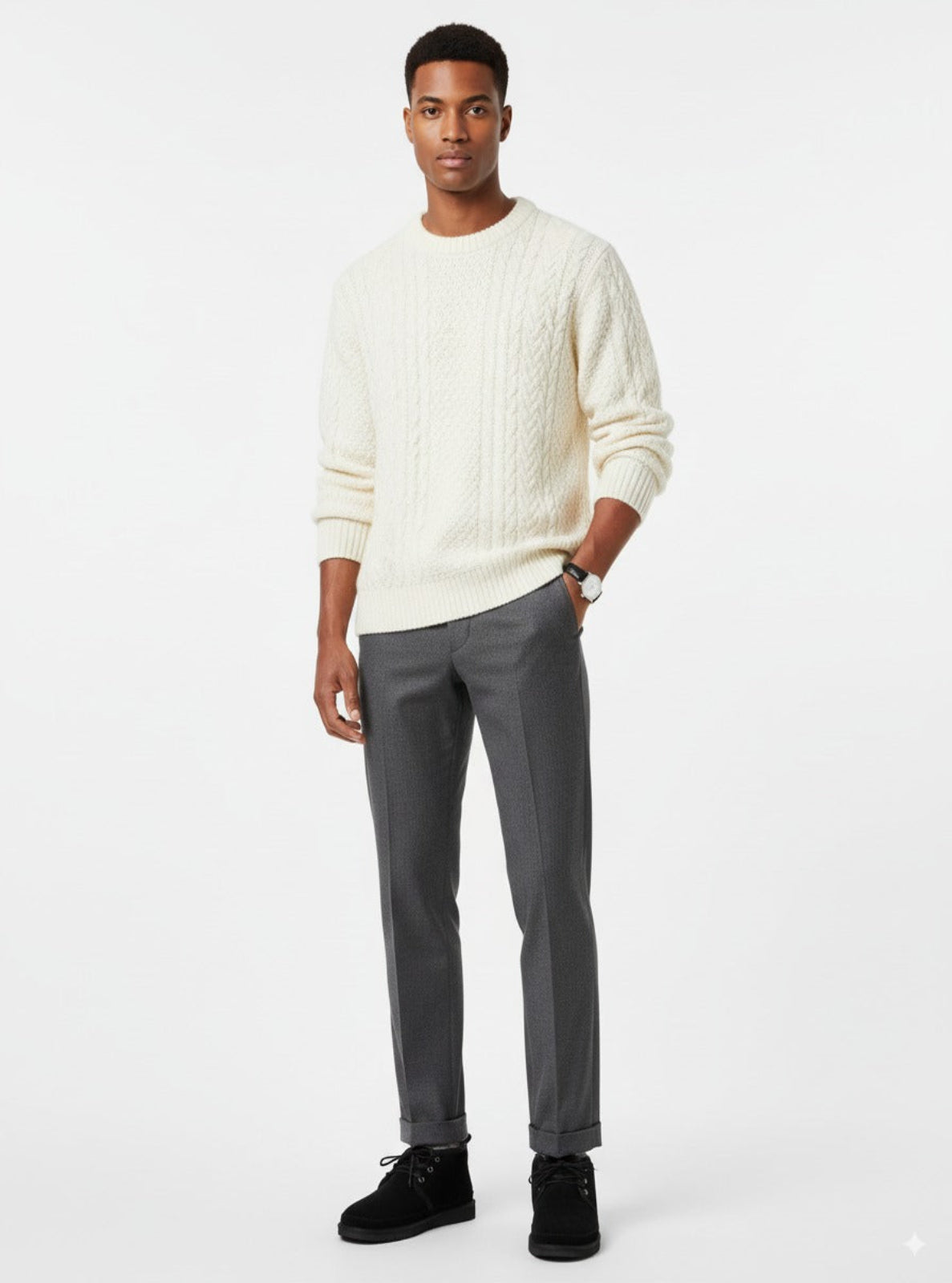Man wearing a white sweater and gray pants on a white background