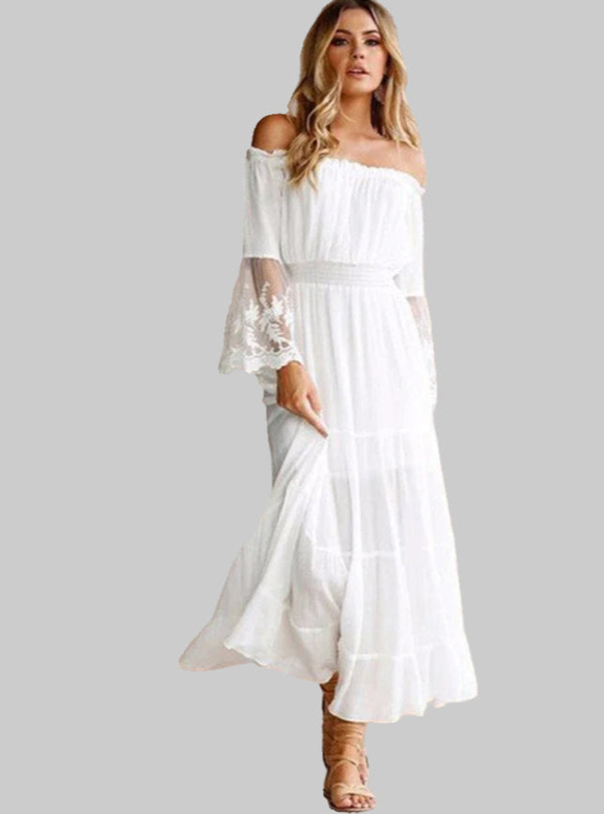 Woman wearing a white off-shoulder dress on a gray background