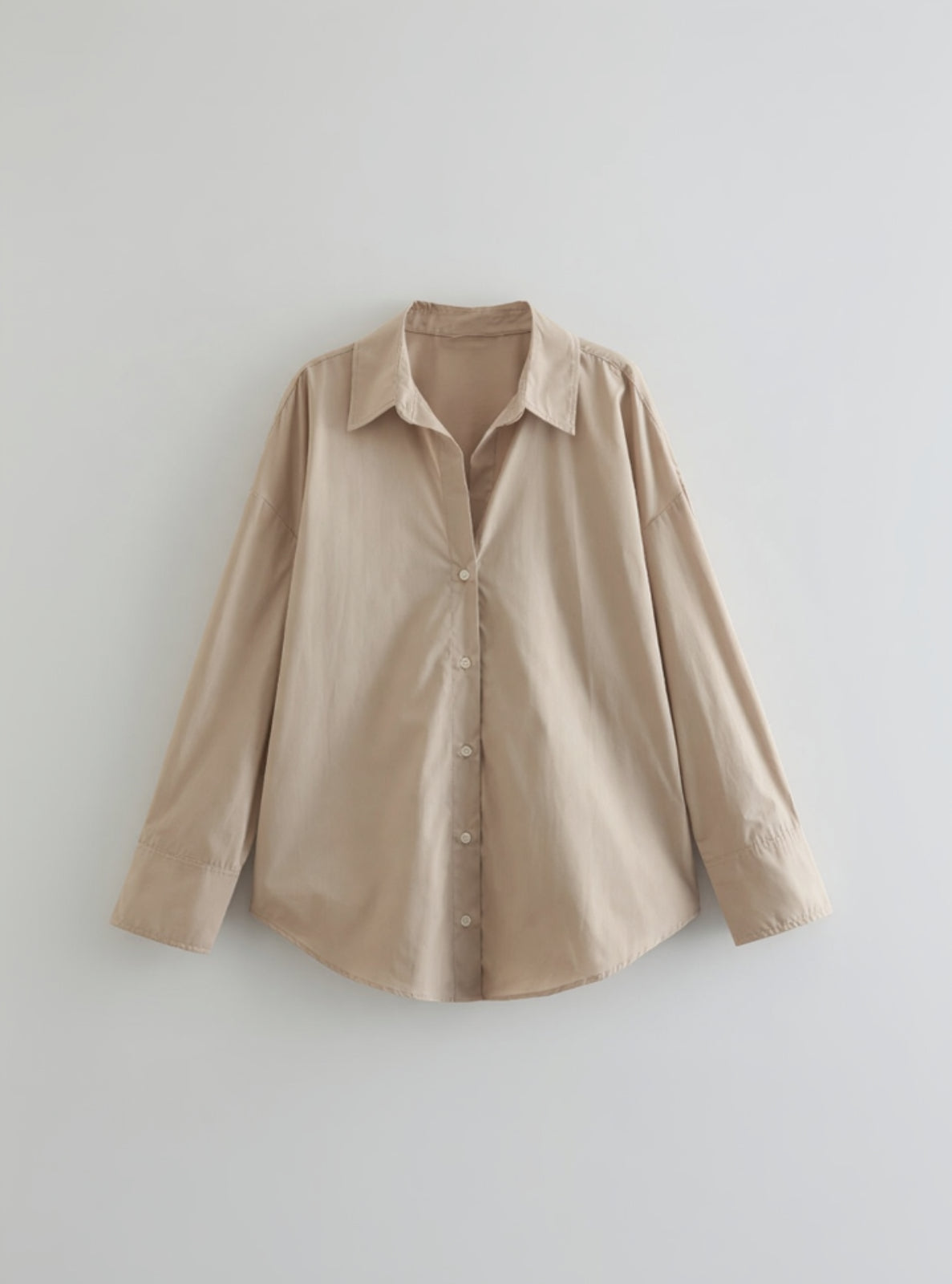 Beige button-up shirt on a light gray background