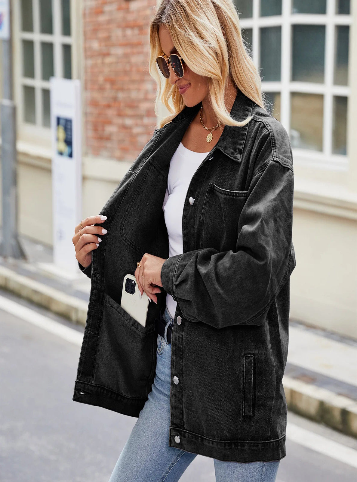 Woman wearing a black denim jacket outdoors