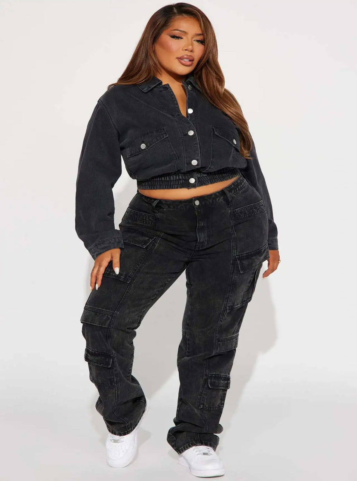 Person wearing a black denim outfit with a white background
