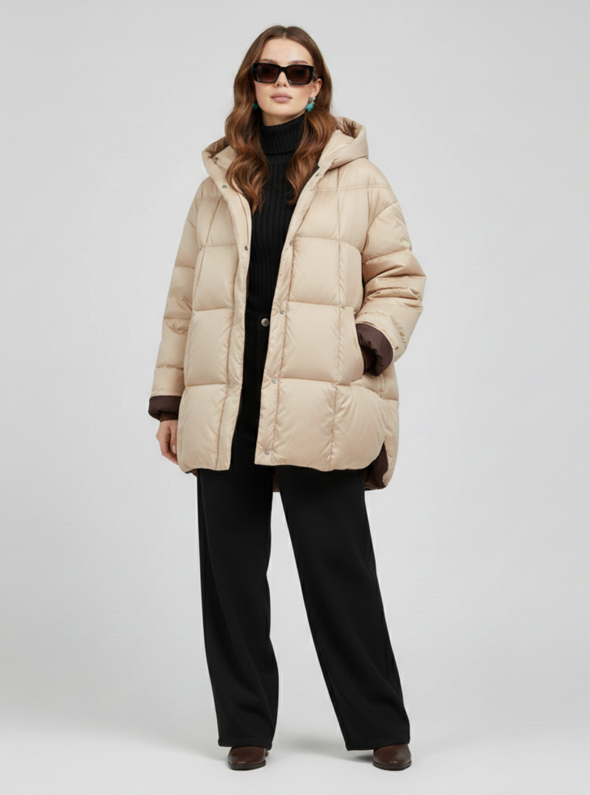 Woman wearing a beige puffer coat on a white background