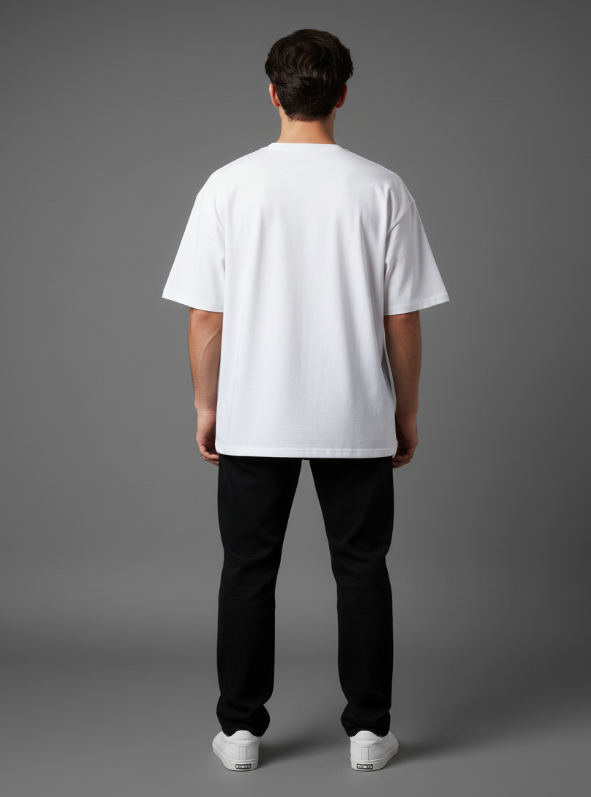 Person wearing a white t-shirt and black pants on a gray background