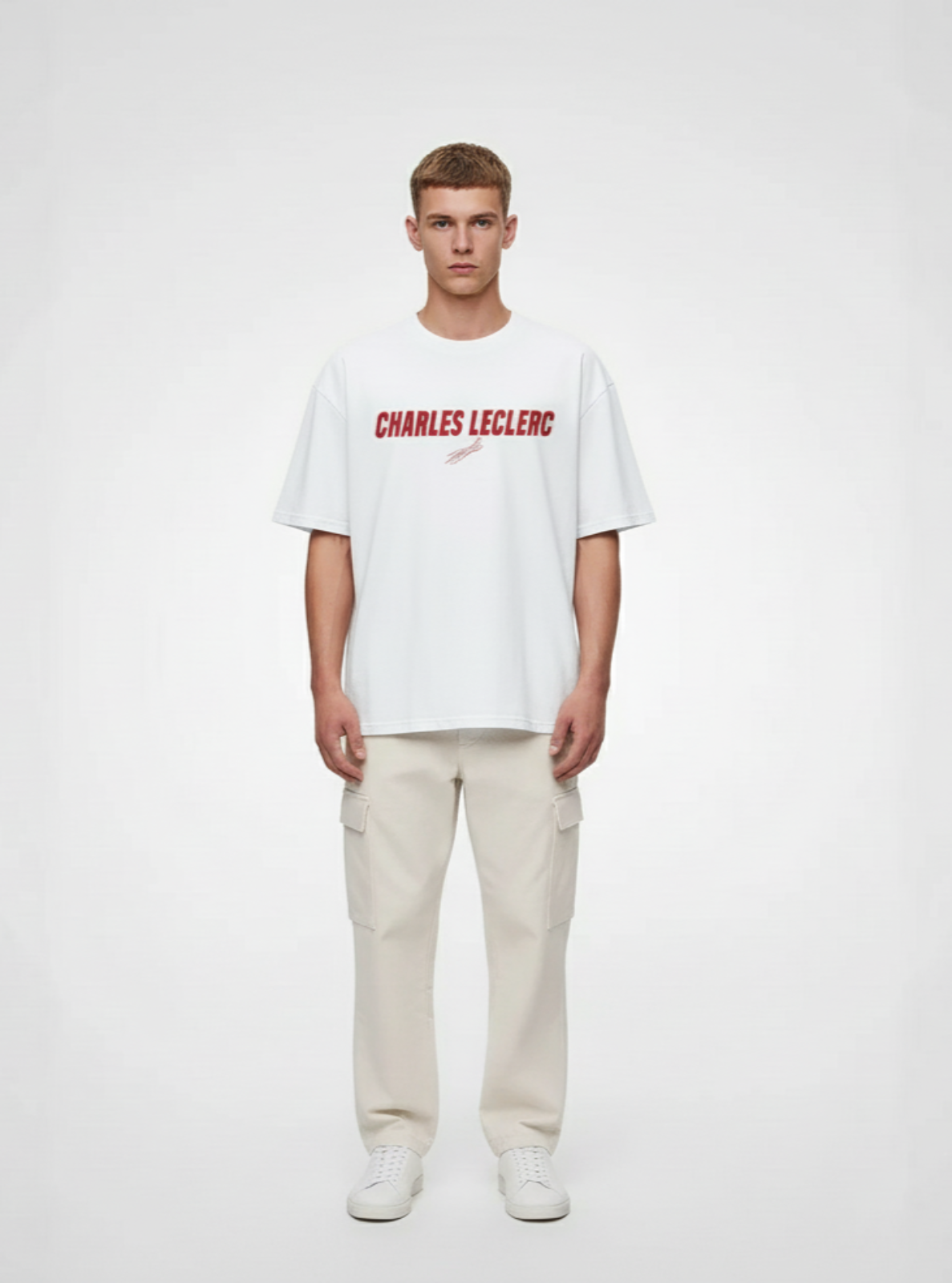 Person wearing a white t-shirt with 'CHARLES LECLERC' text on a plain background