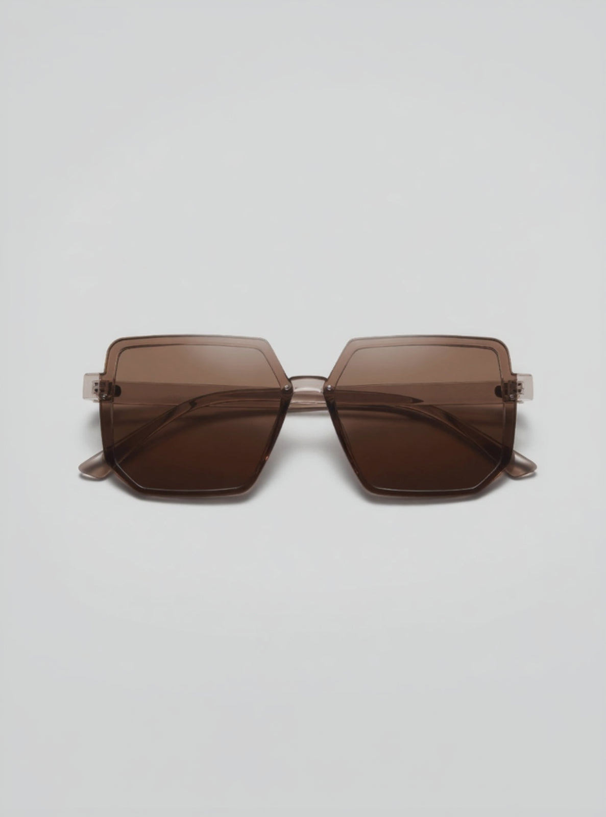Brown sunglasses on a light gray background