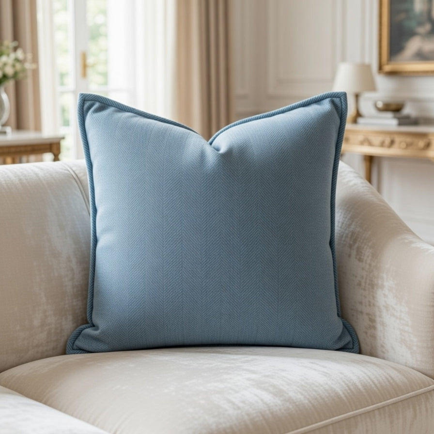 Blue pillow on a beige sofa in a living room setting