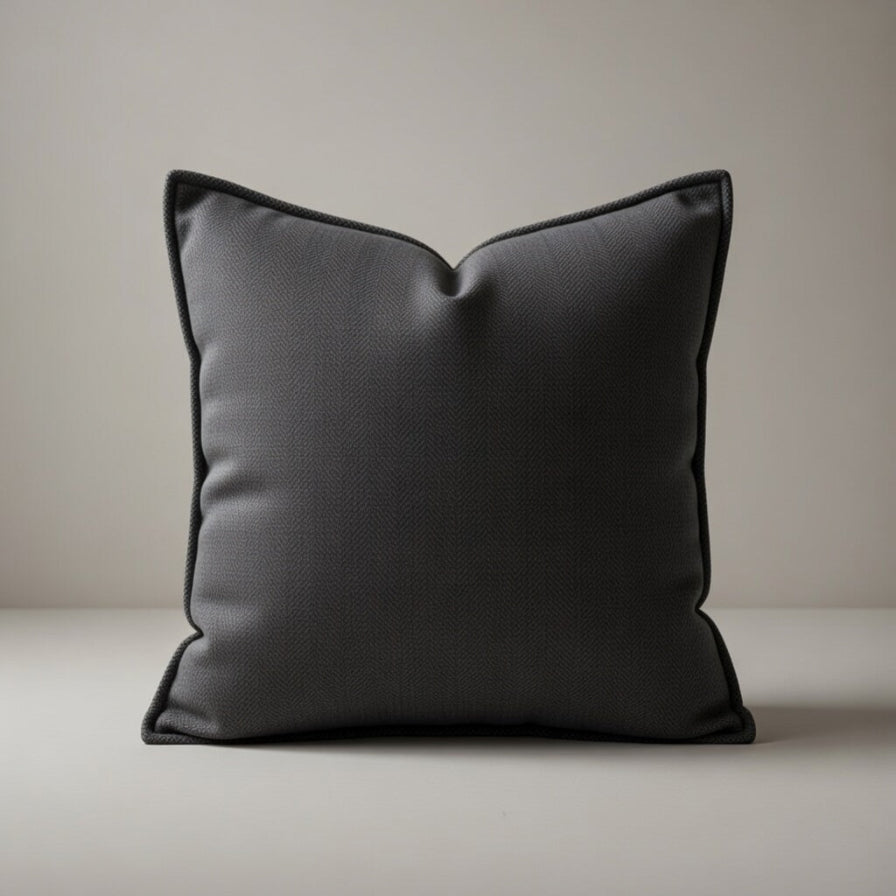 Dark gray pillow on a neutral background