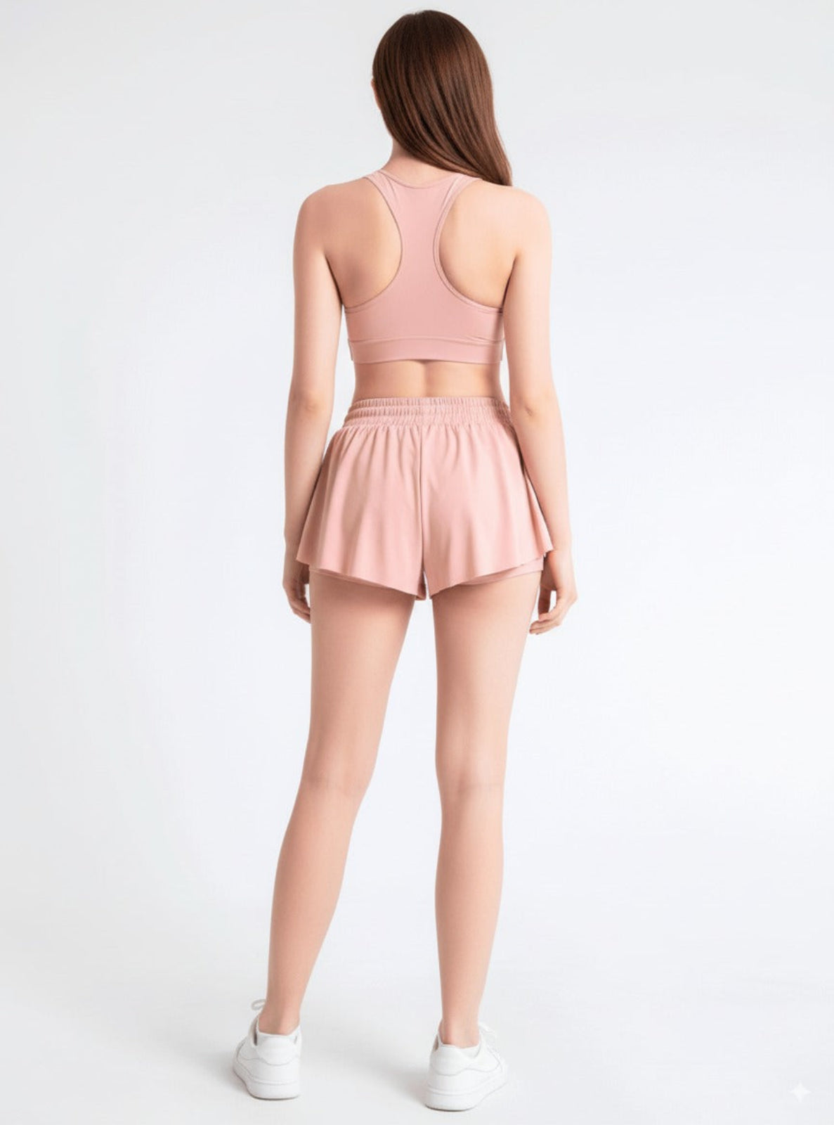 Person wearing a pink athletic outfit on a white background