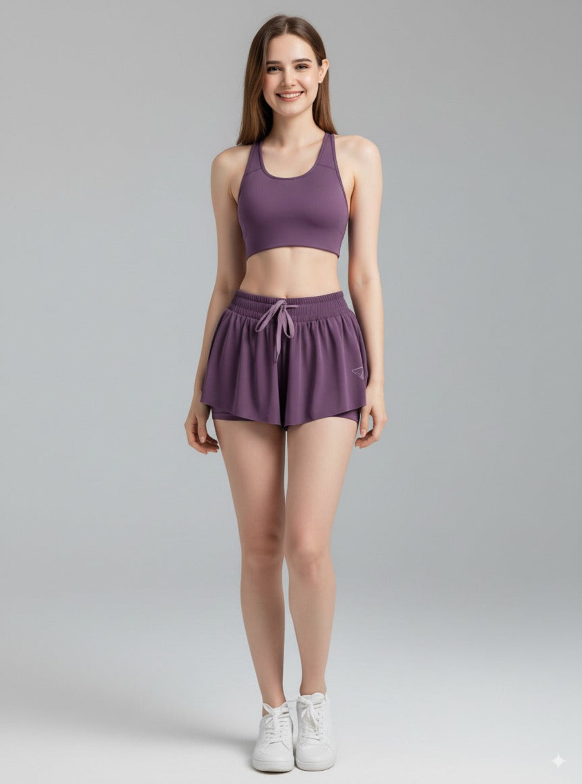 Woman wearing a purple athletic outfit on a gray background