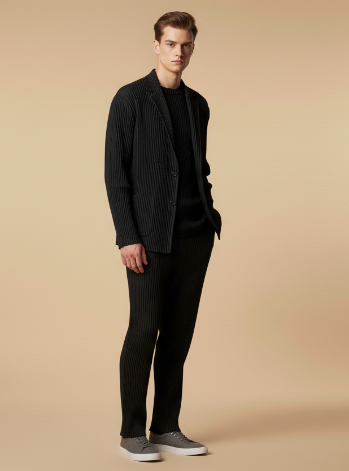 Man wearing a black suit and shoes on a beige background