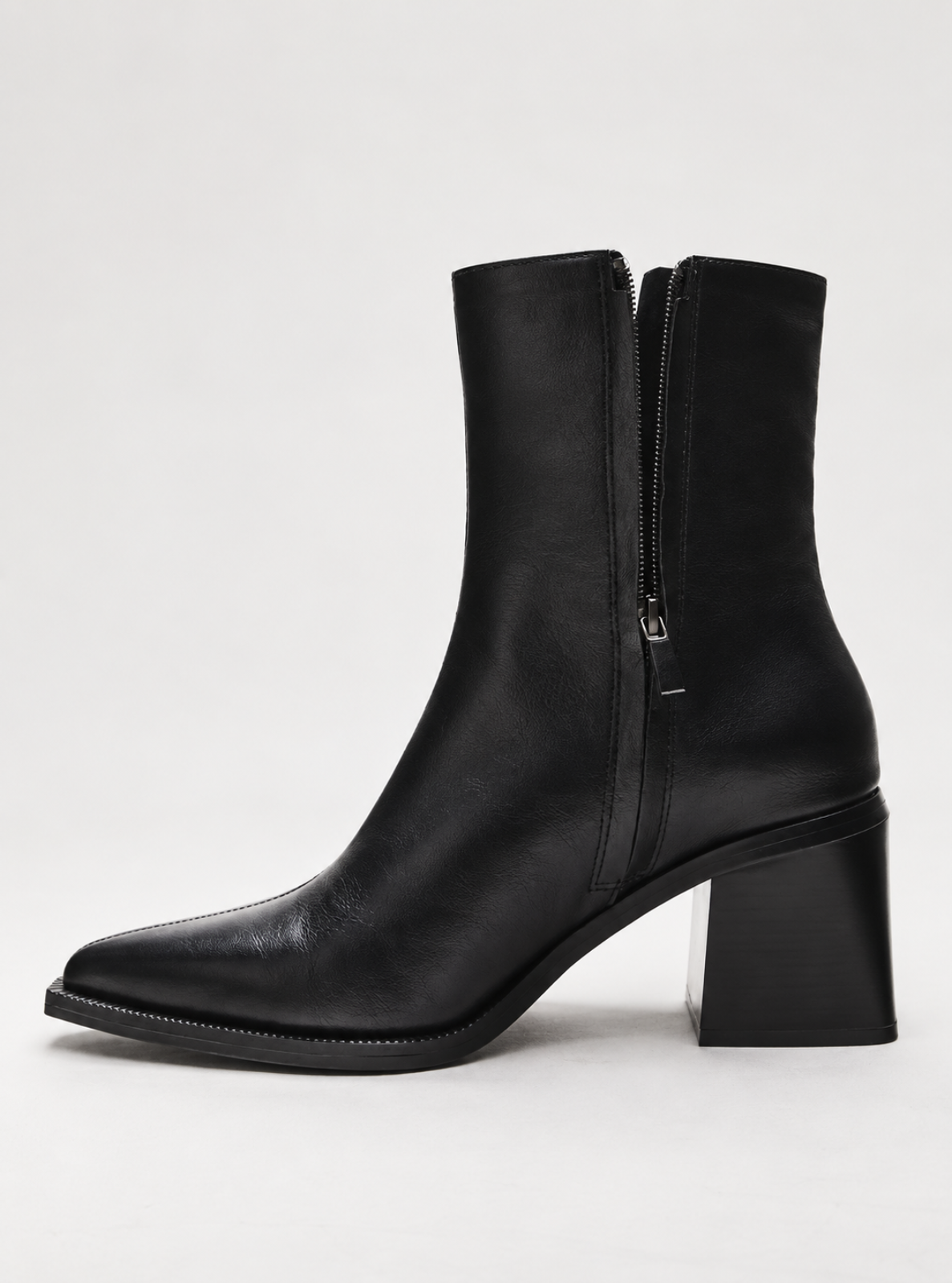 A black leather ankle boot with a side zipper, block heel, and pointed toe, shown in profile against a light gray background.