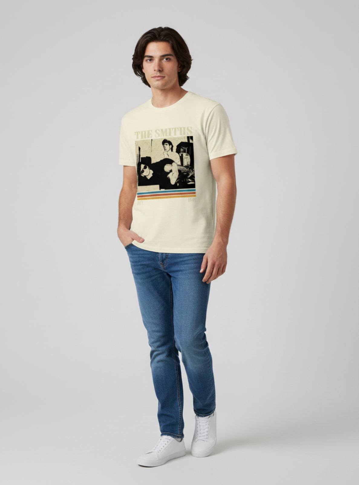 Man wearing a graphic t-shirt and jeans on a plain background