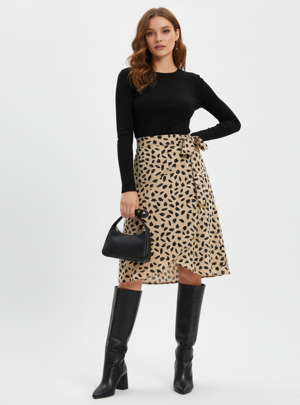 Woman wearing a black top, leopard print skirt, and black knee-high boots on a white background