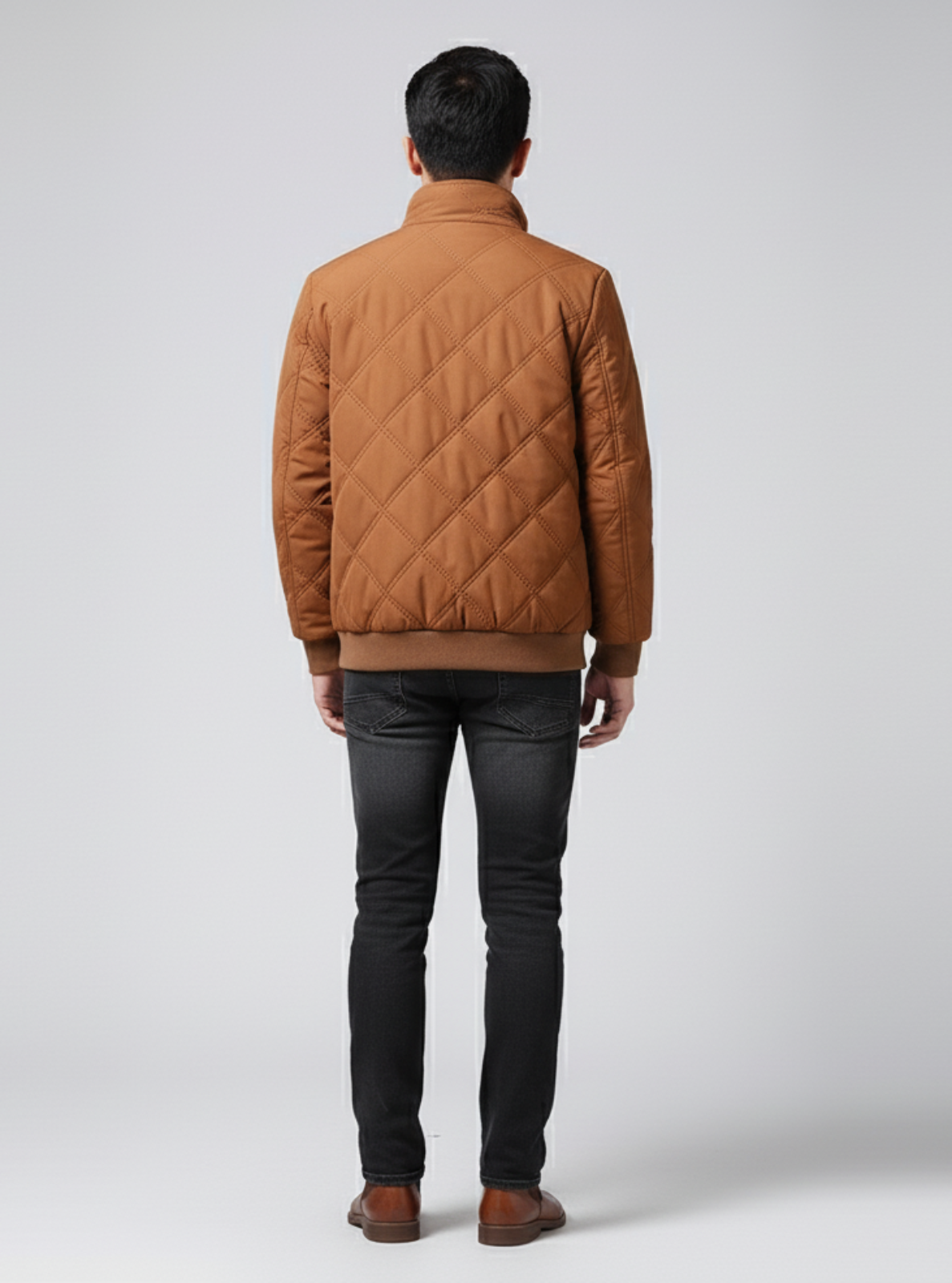 Person wearing a brown quilted jacket on a white background