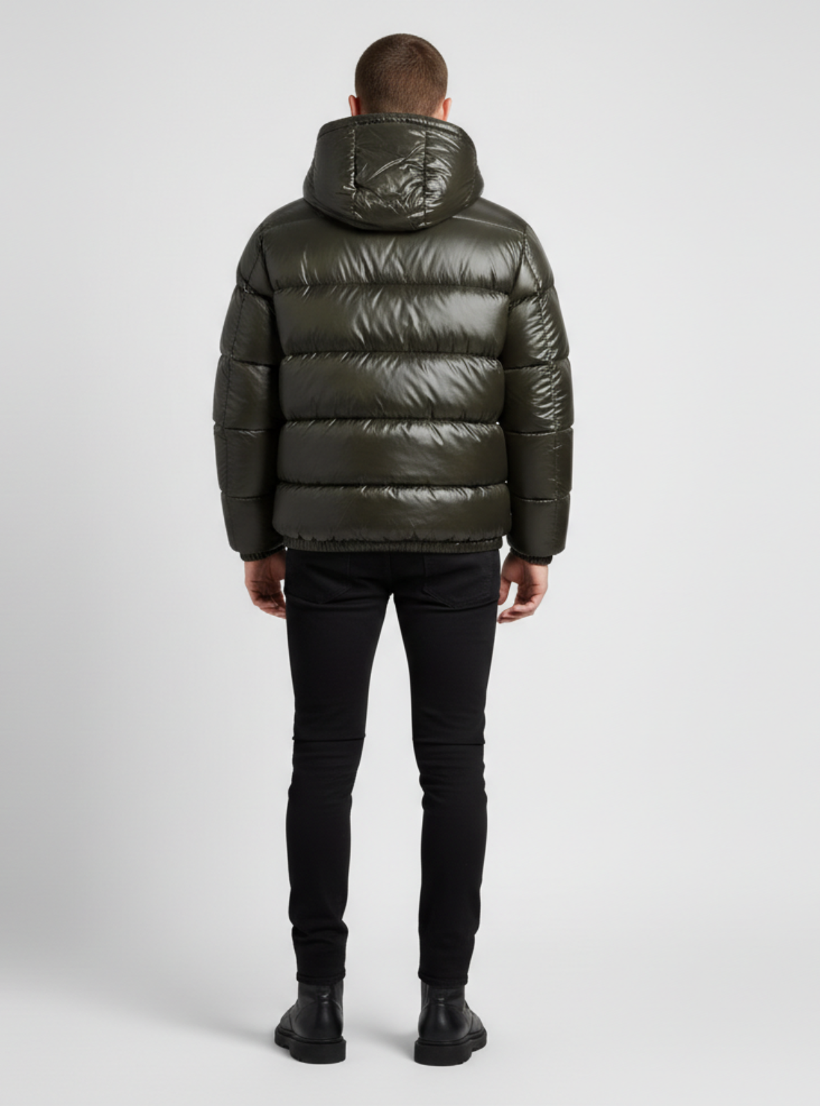 Person wearing a green puffer jacket on a white background