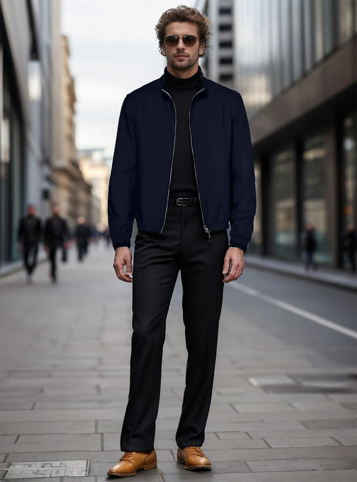 Man in a navy jacket and black pants standing on a city street.