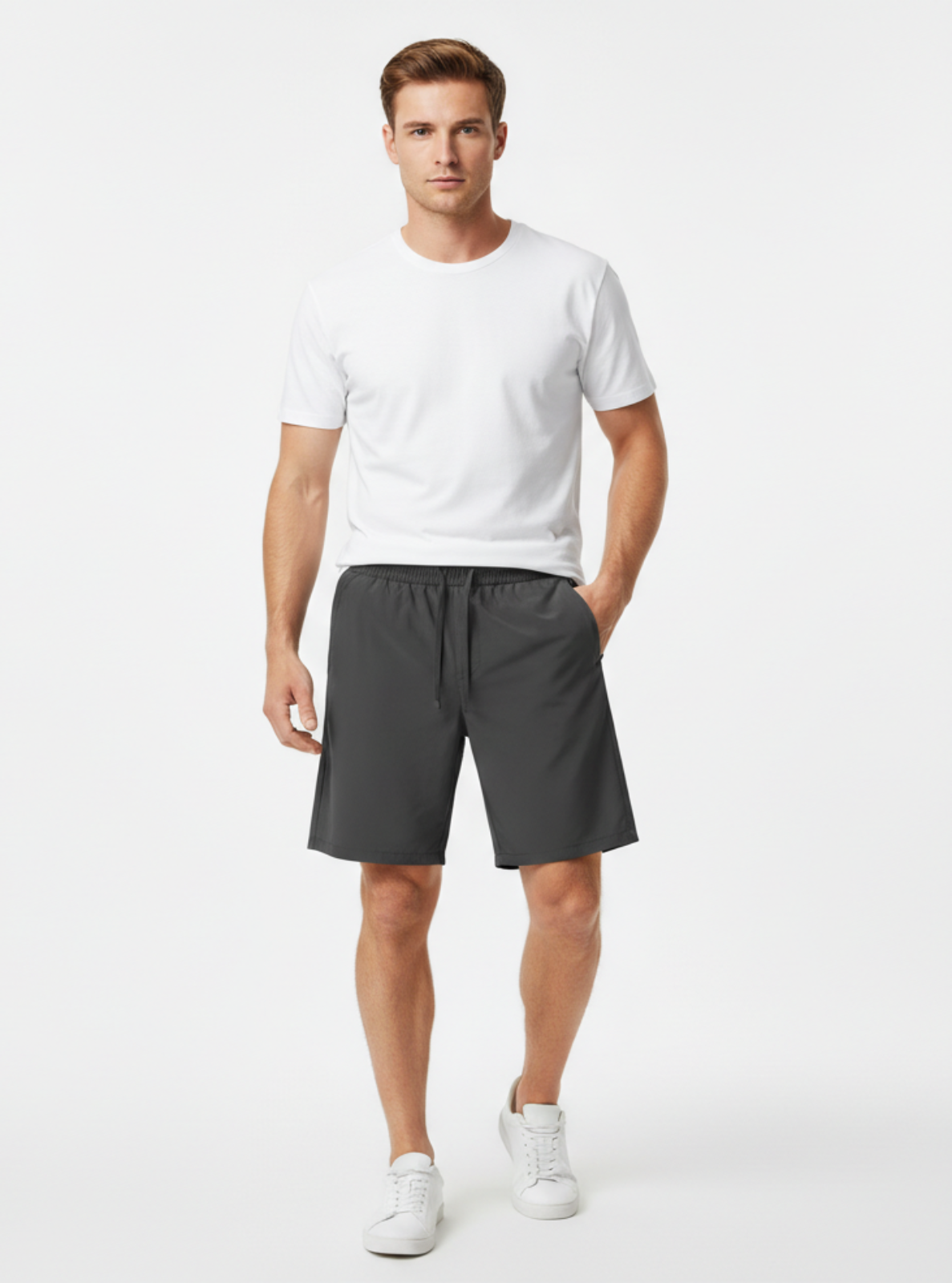 Man wearing a white t-shirt and gray shorts on a white background