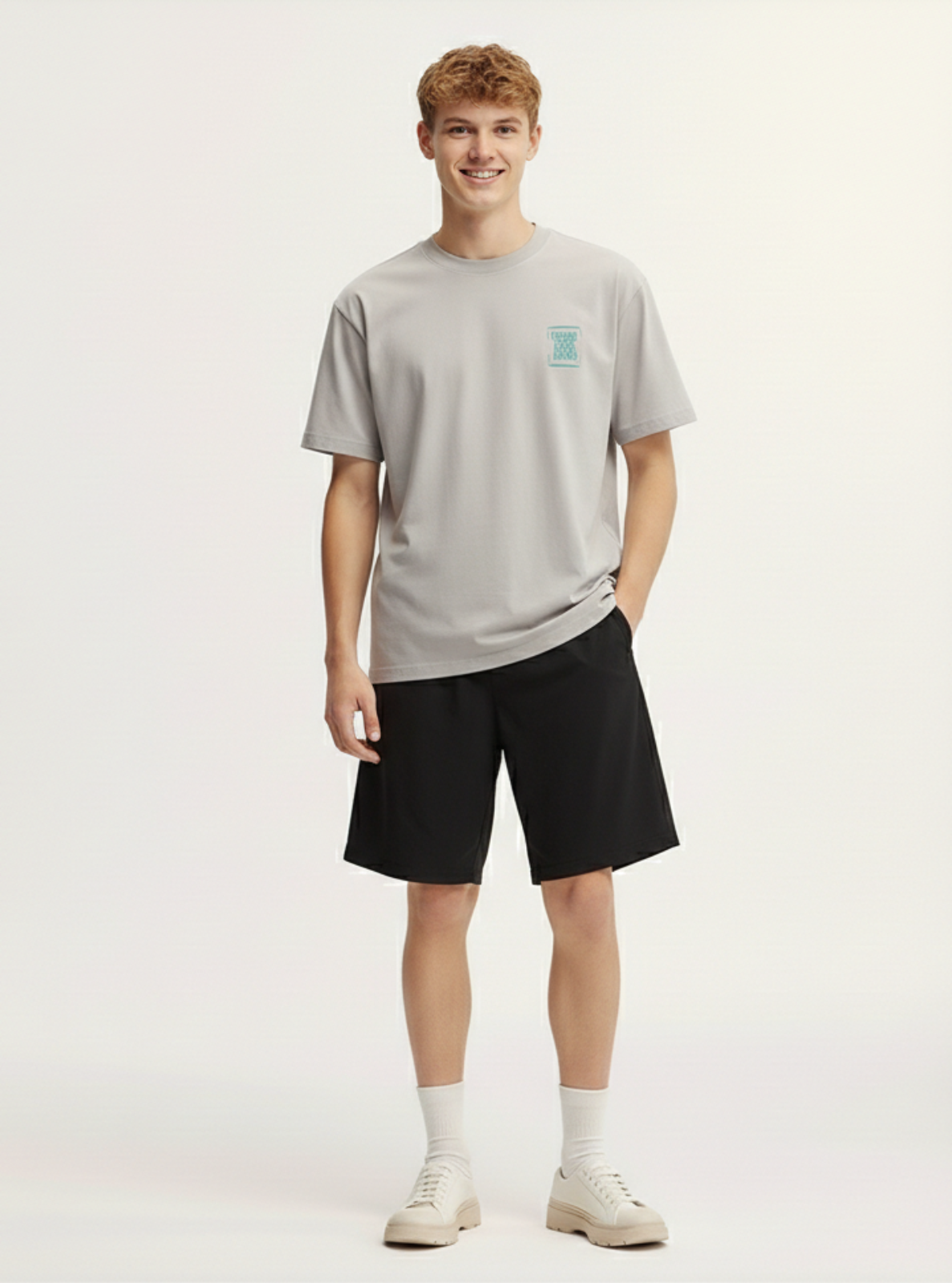 Person wearing a gray t-shirt and black shorts on a white background