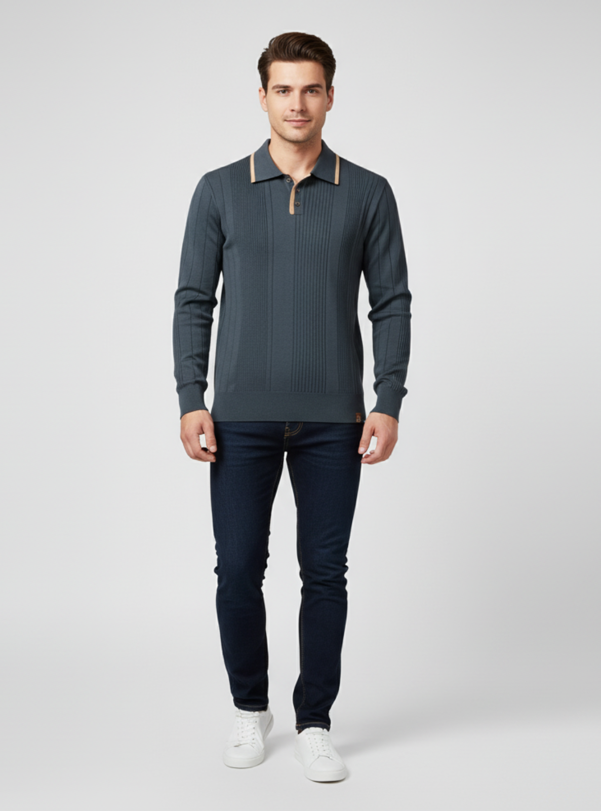 Man wearing a dark green sweater and jeans on a light gray background