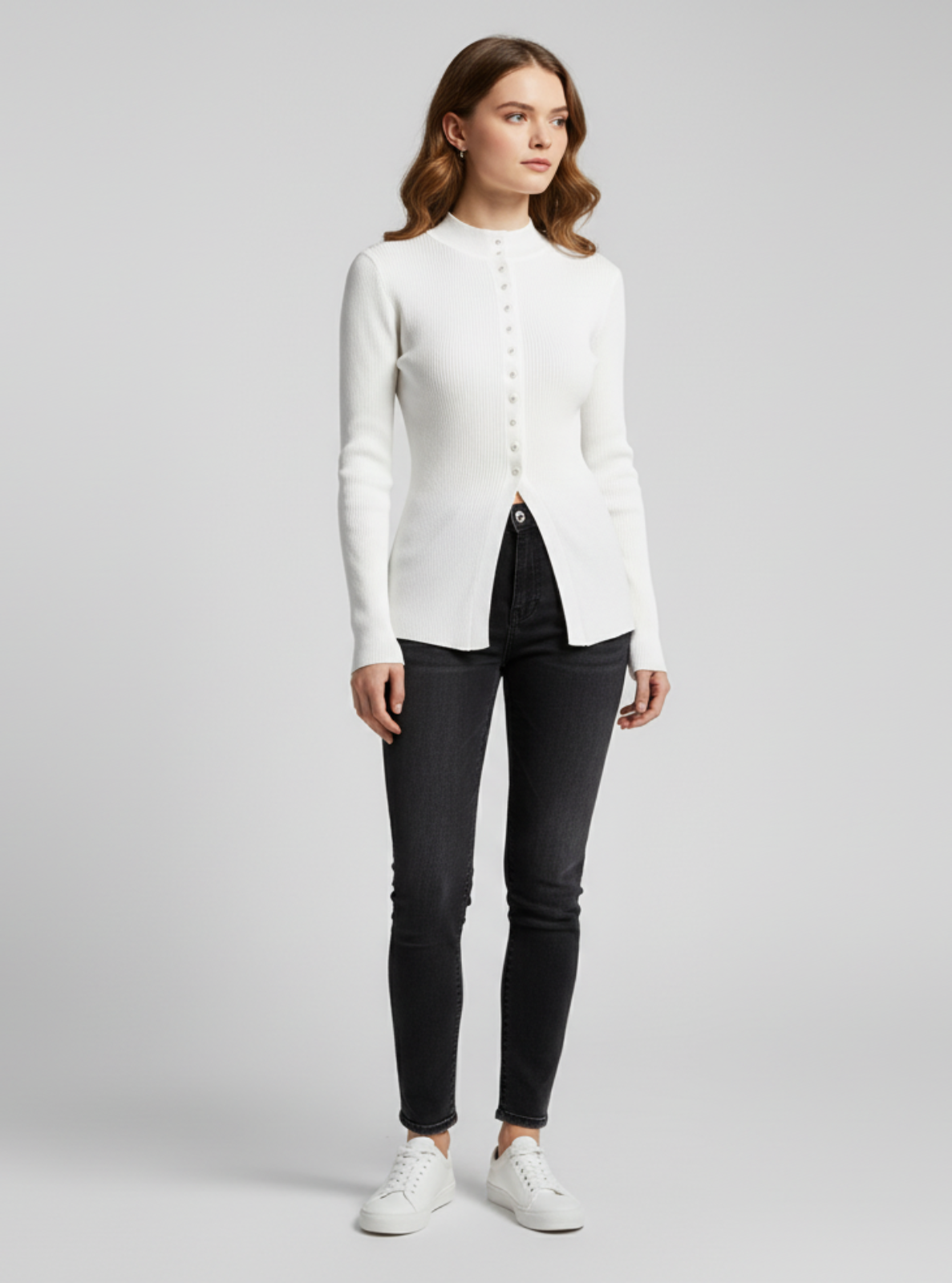 Woman wearing a white shirt and black pants on a gray background