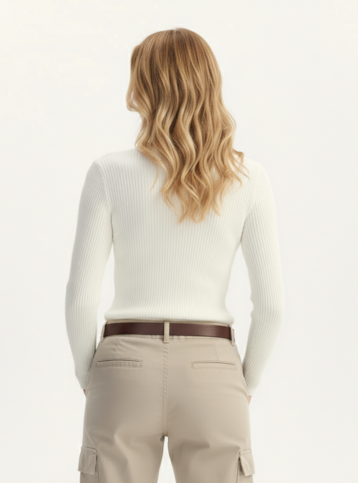 Person wearing a white long-sleeve top and beige cargo pants on a white background