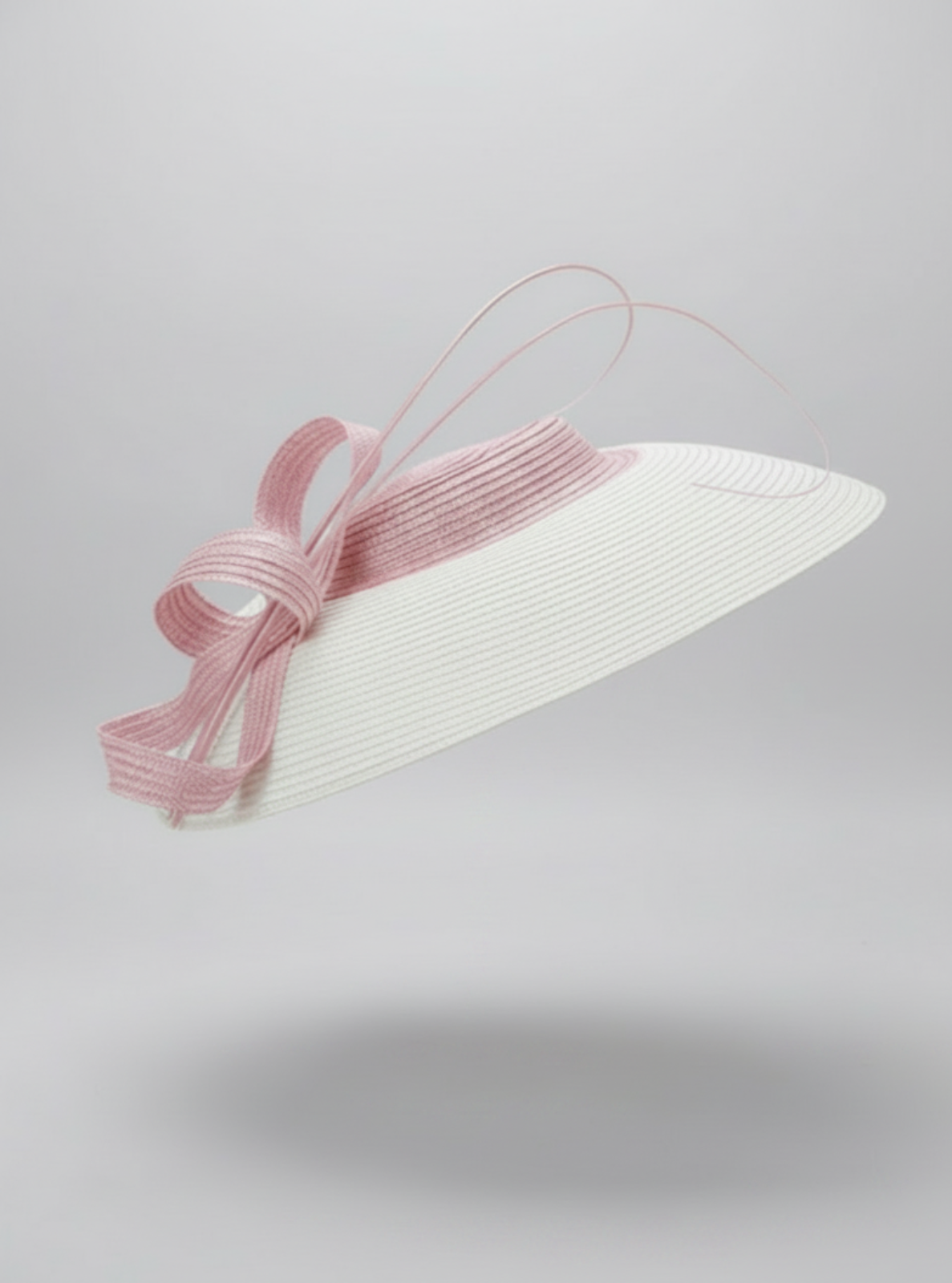 White hat with a pink ribbon on a light gray background