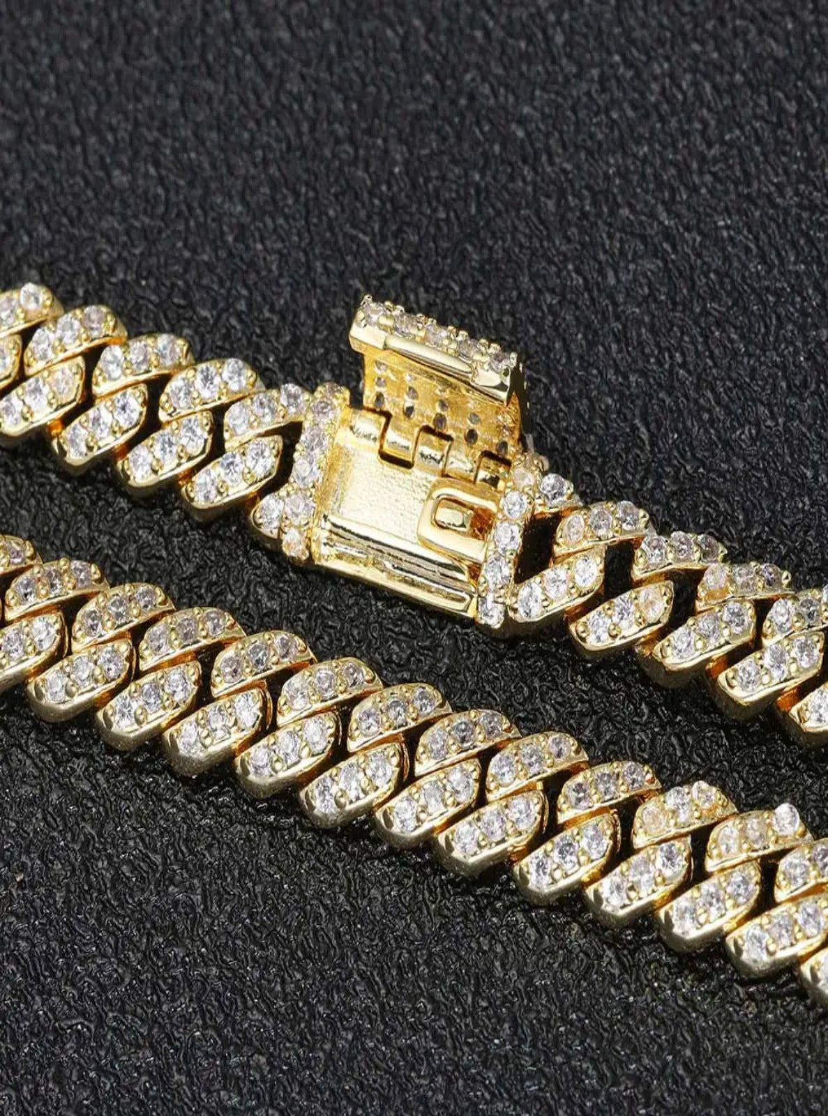 Gold chain necklace with a clasp on a black background