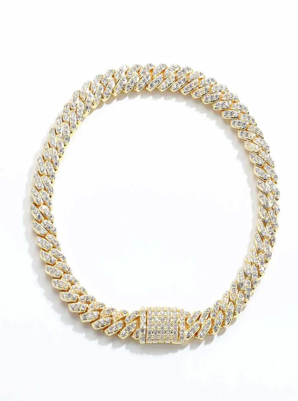 Gold chain necklace with clear stones on a white background