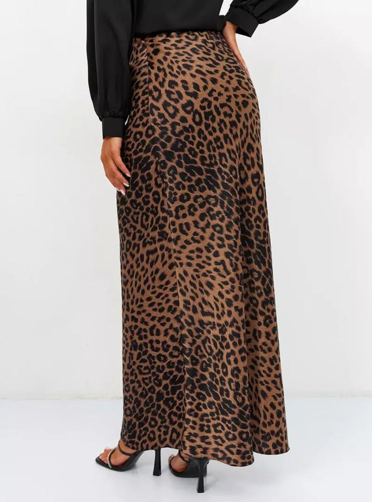 Leopard print skirt worn by a person on a white background