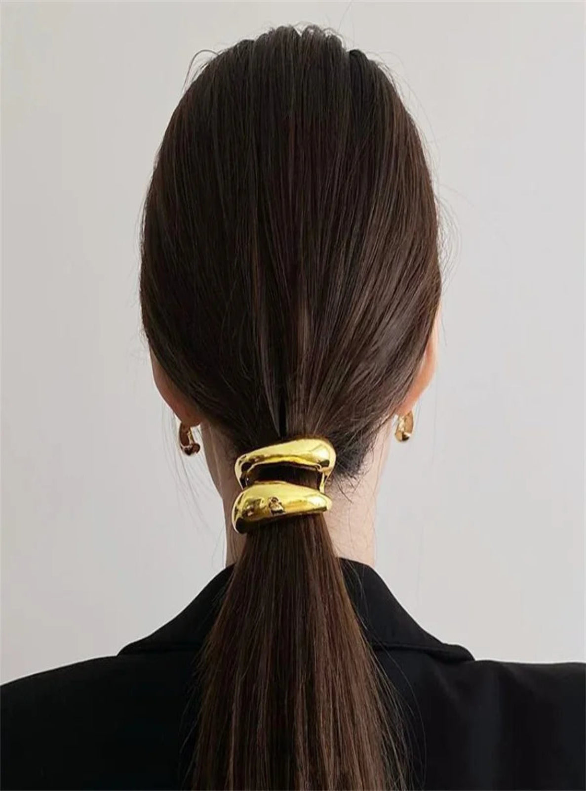 gold hair clip accessory in ponytail 