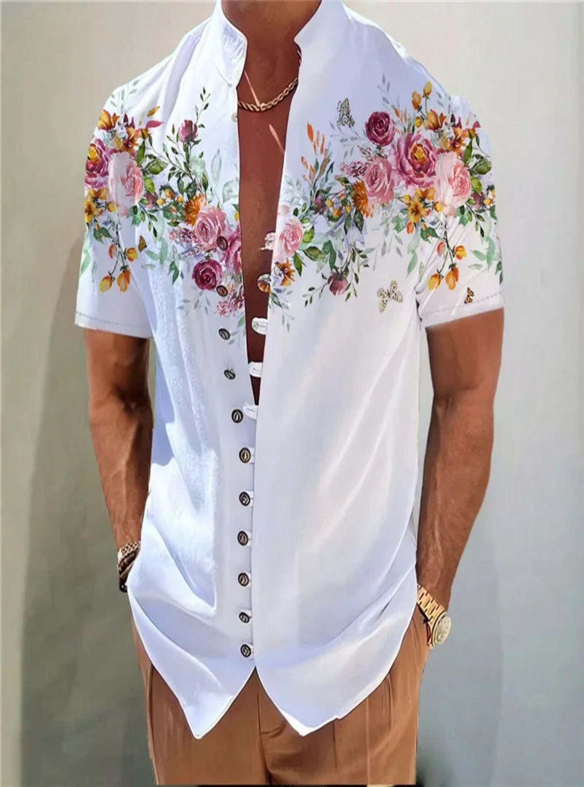 White floral shirt worn by a person on a plain background