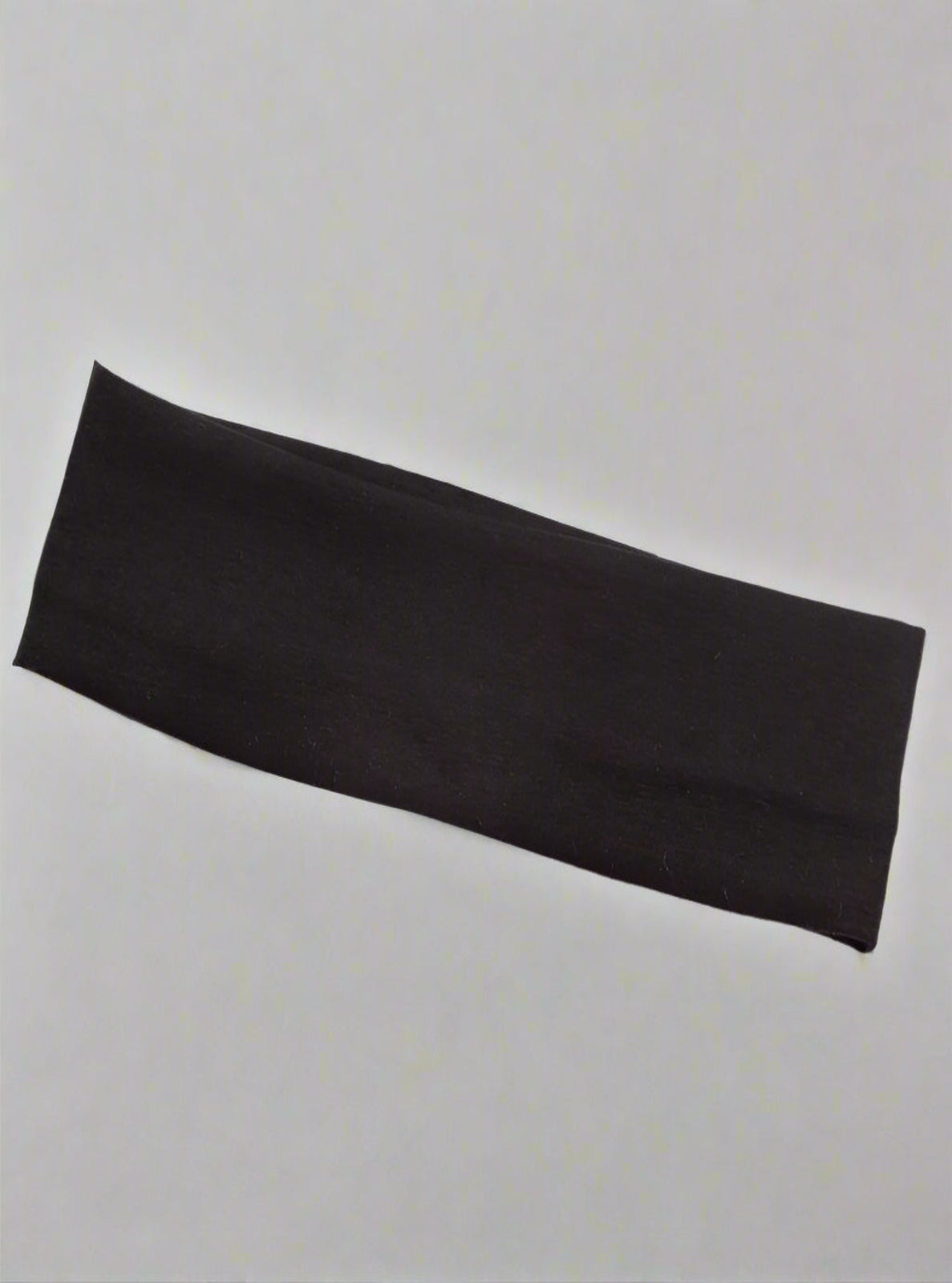 Black headband on a white surface 