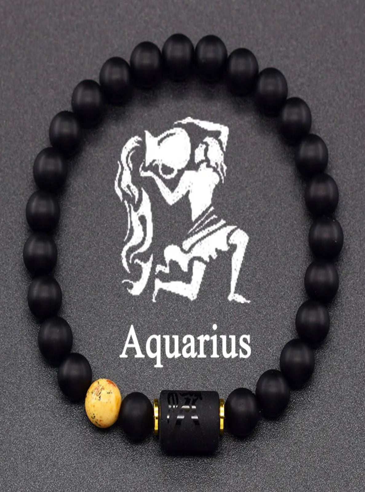 Black beaded bracelet with Aquarius symbol and name on a gray background