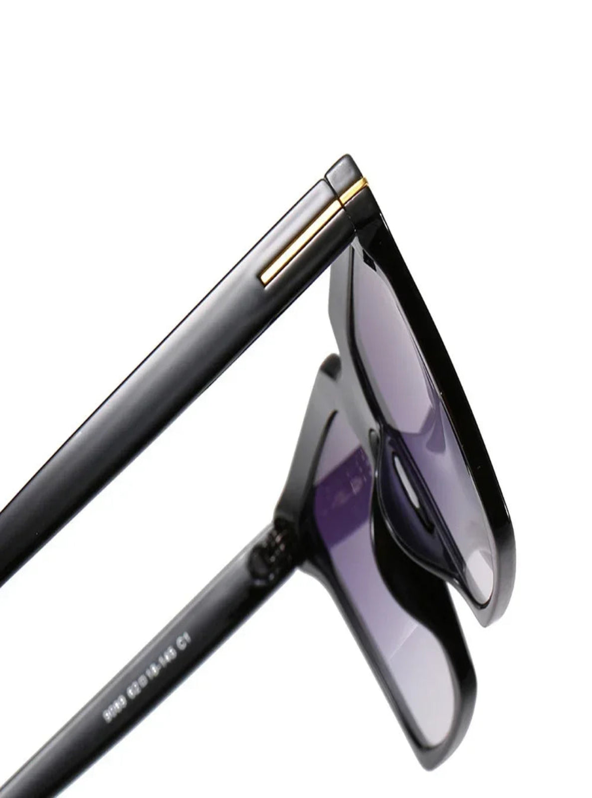Black sunglasses with gold accents on a white background
