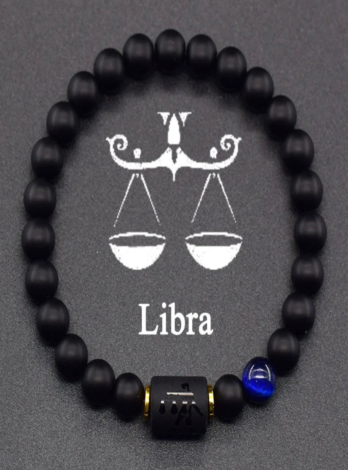 Black beaded bracelet with Libra zodiac symbol on a gray background