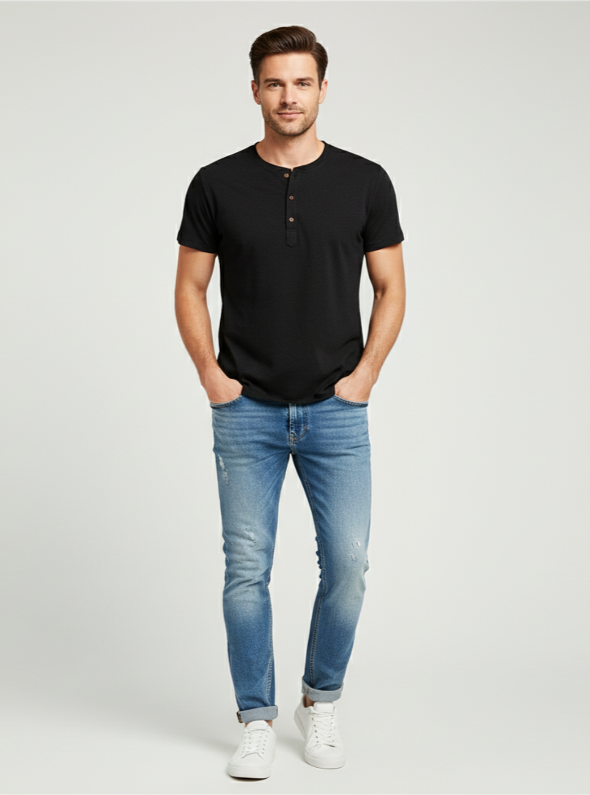 Man wearing a black t-shirt and blue jeans on a white background