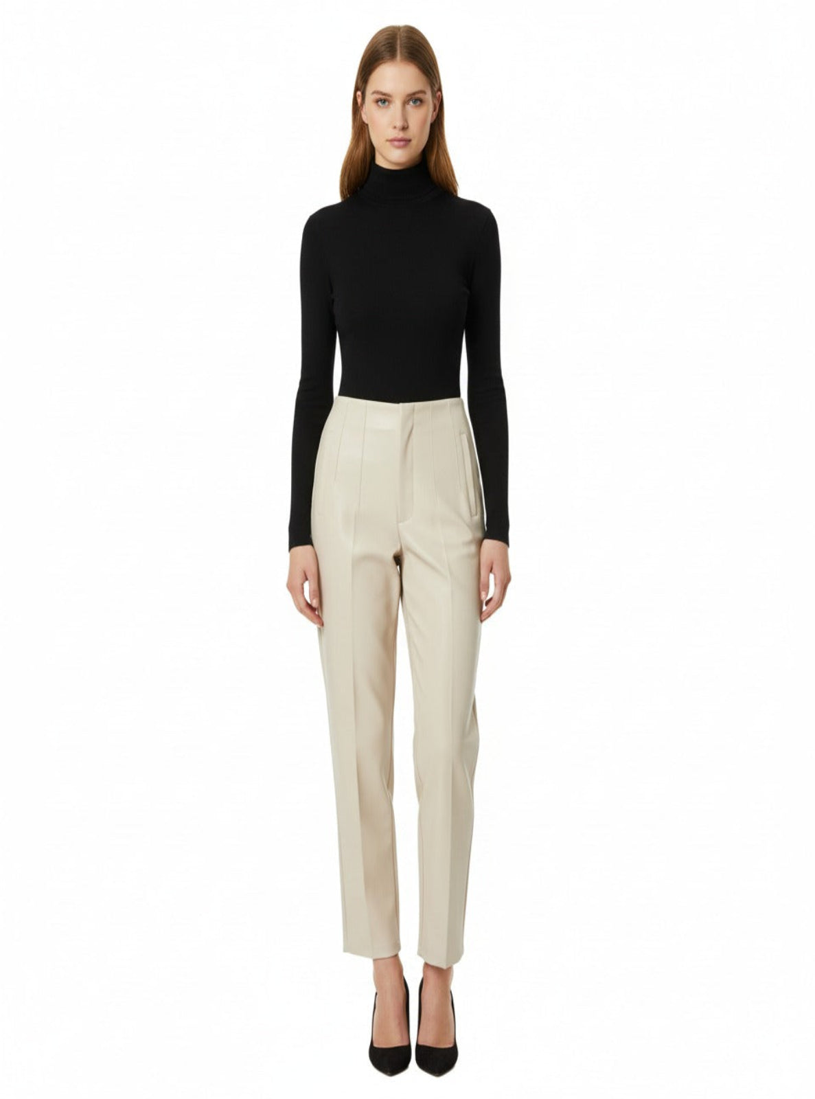 Woman wearing a black turtleneck and beige pants on a white background