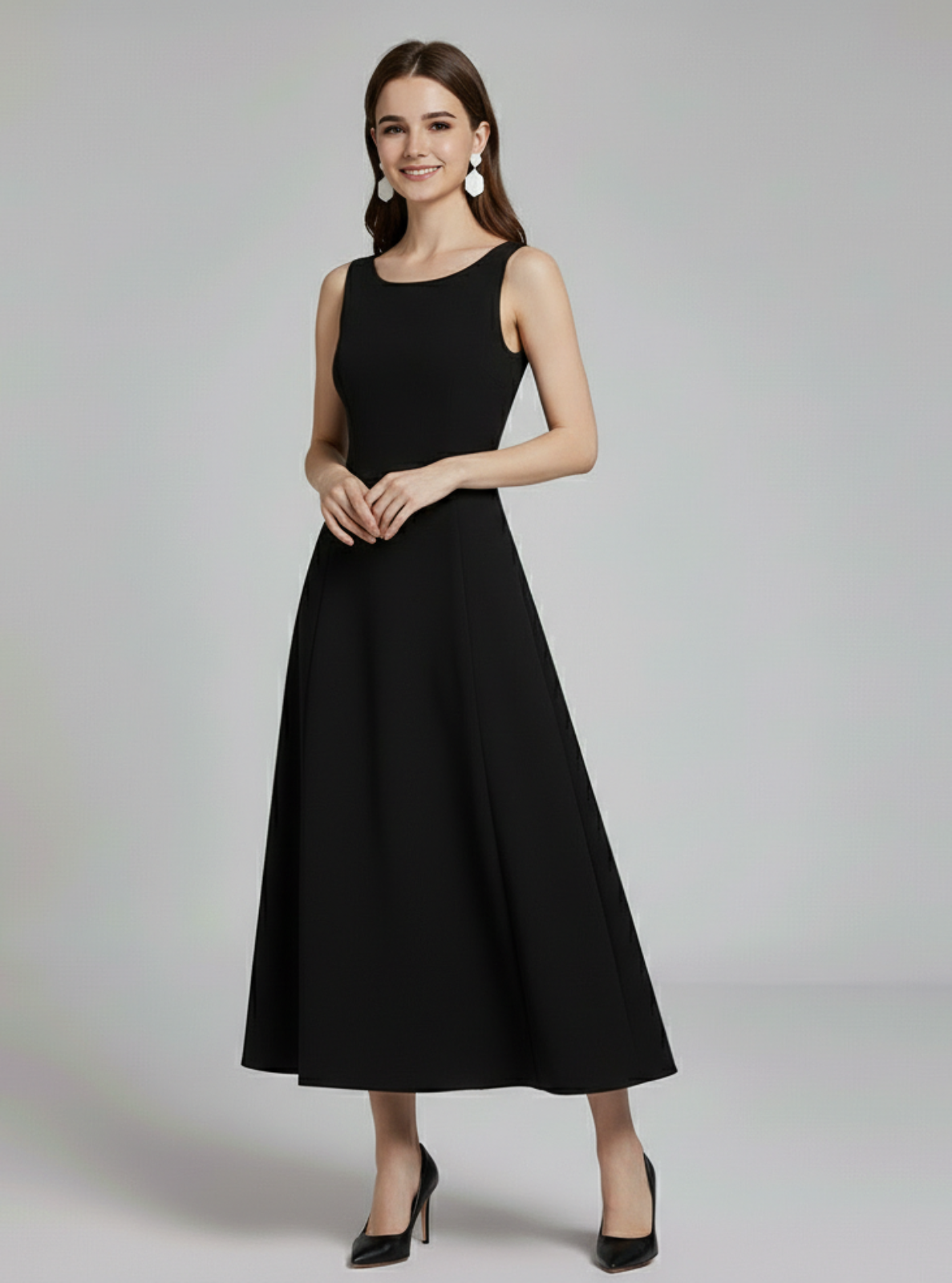 Woman wearing a black sleeveless dress on a gray background