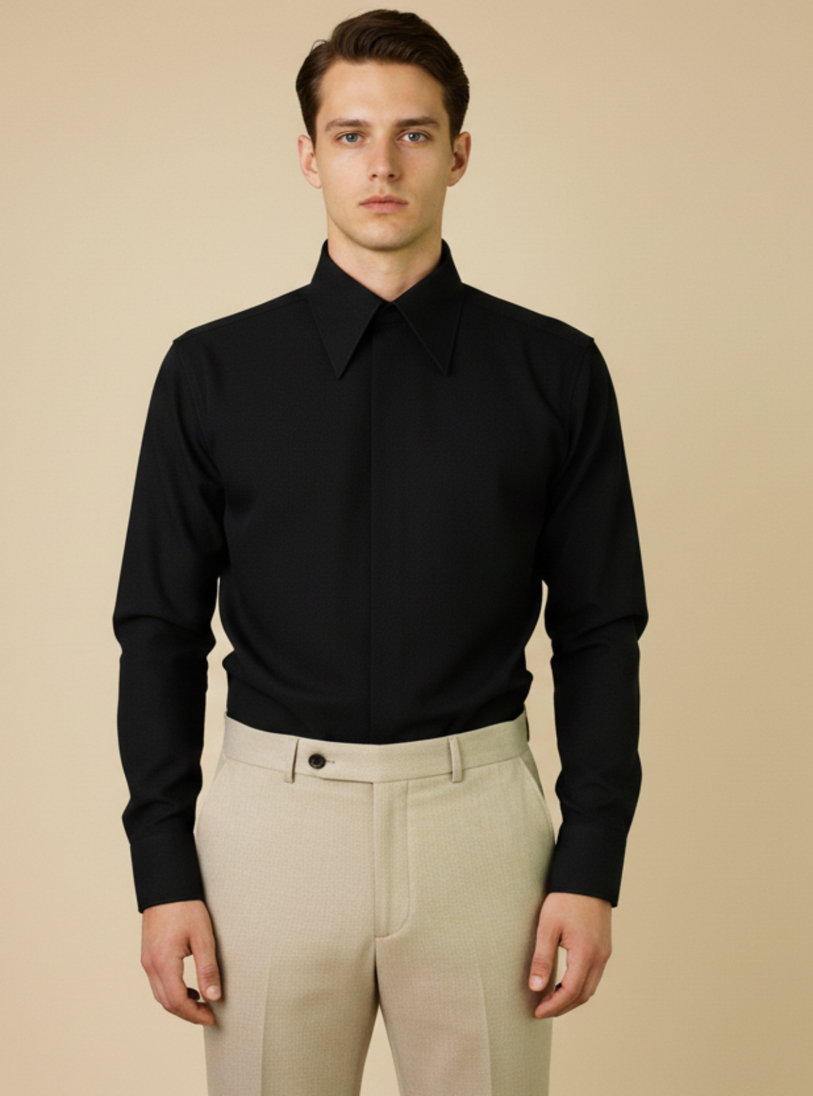 Man wearing a black shirt and beige pants against a beige background
