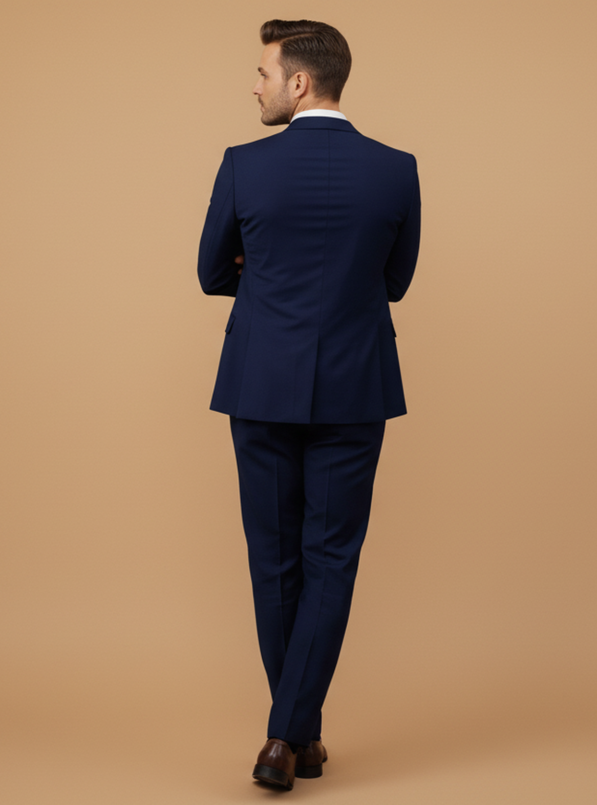 Man wearing a navy blue suit on a beige background