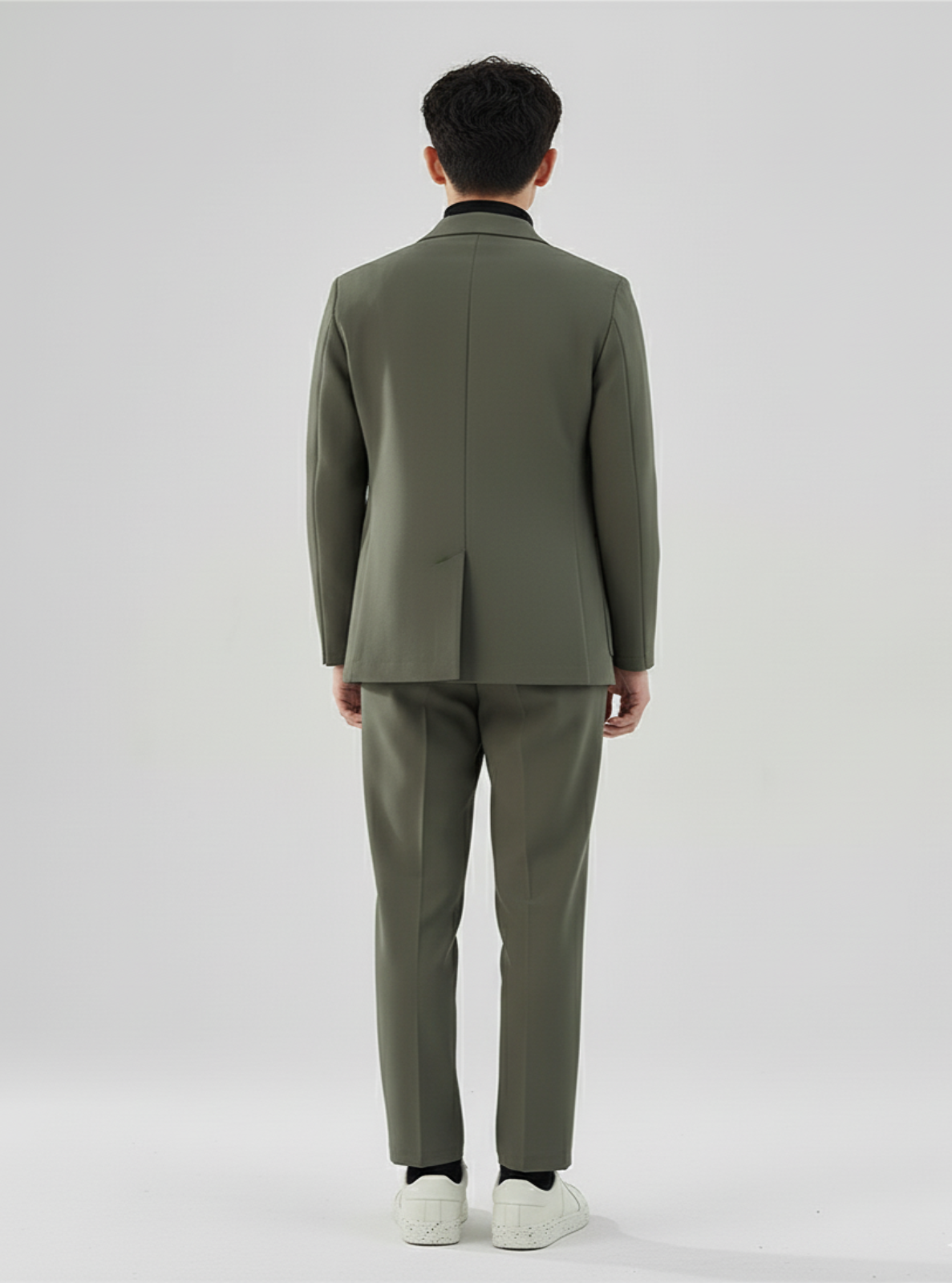 Person wearing a green suit on a white background