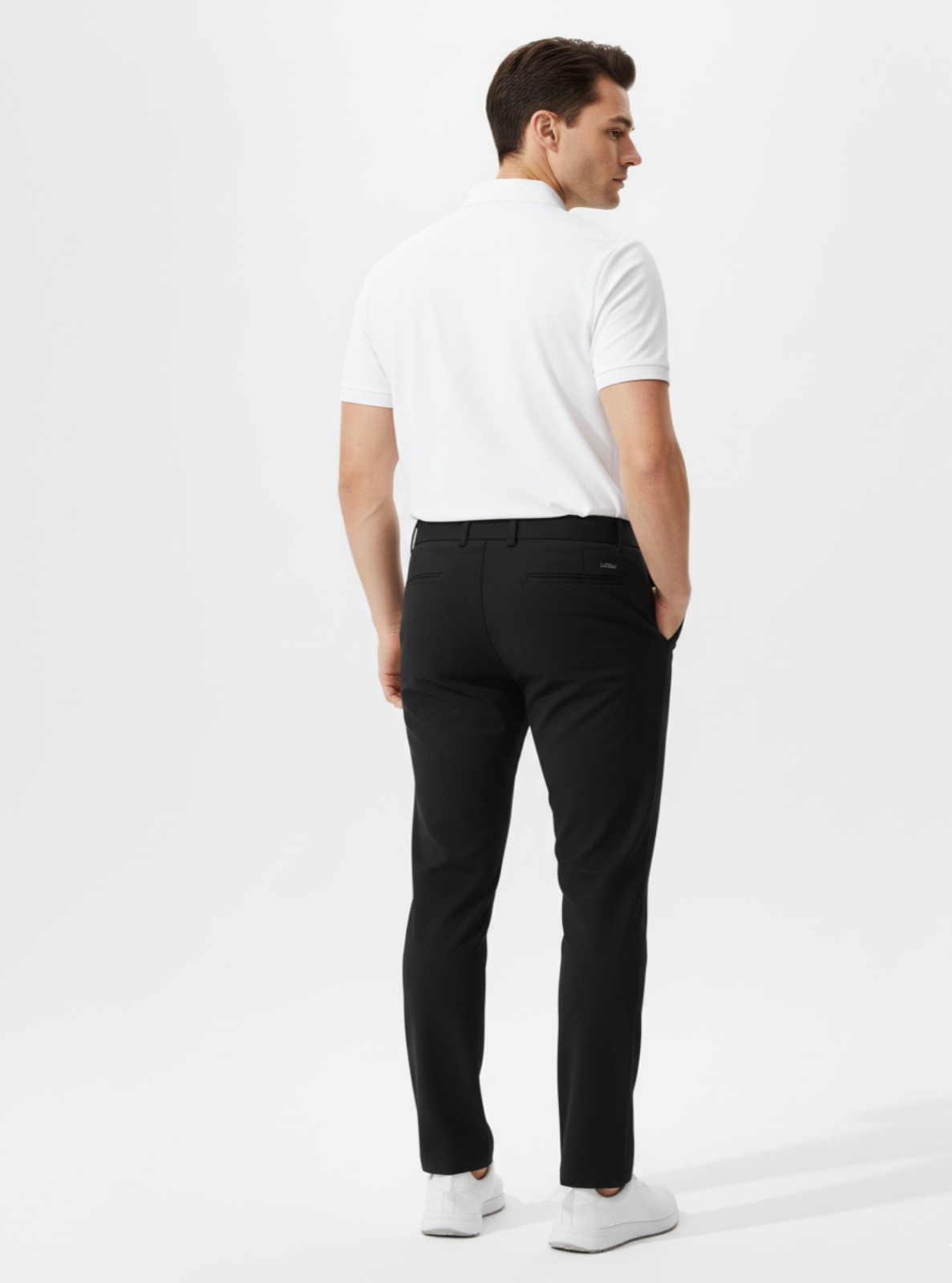 Man wearing a white shirt and black pants on a white background