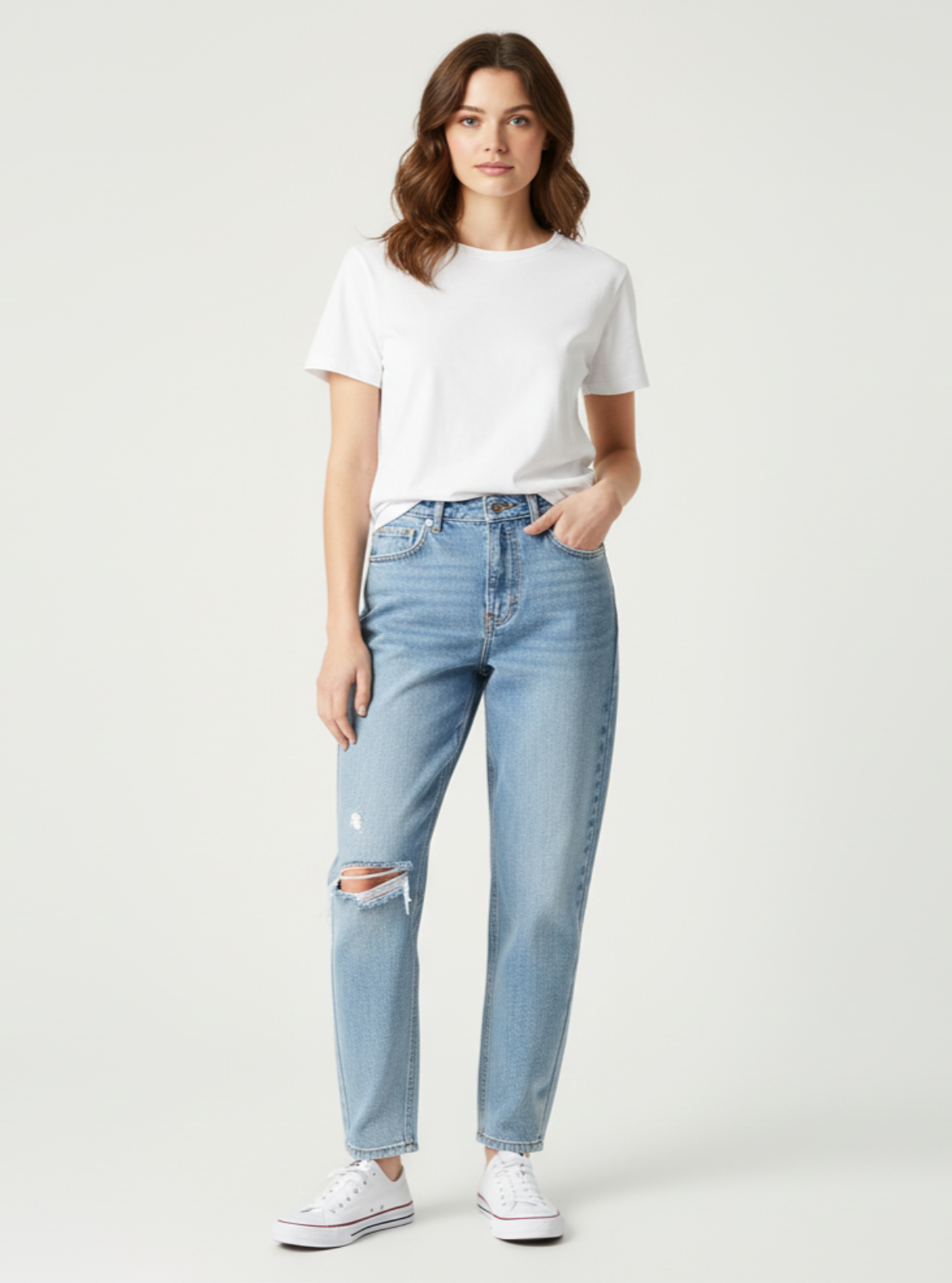 Woman wearing light blue jeans and a white t-shirt on a white background