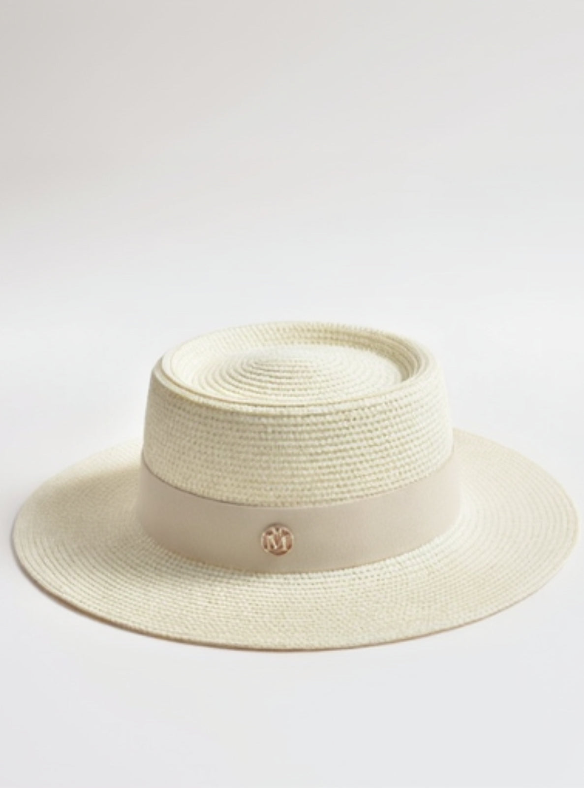 Beige straw hat with a logo on a light gray background