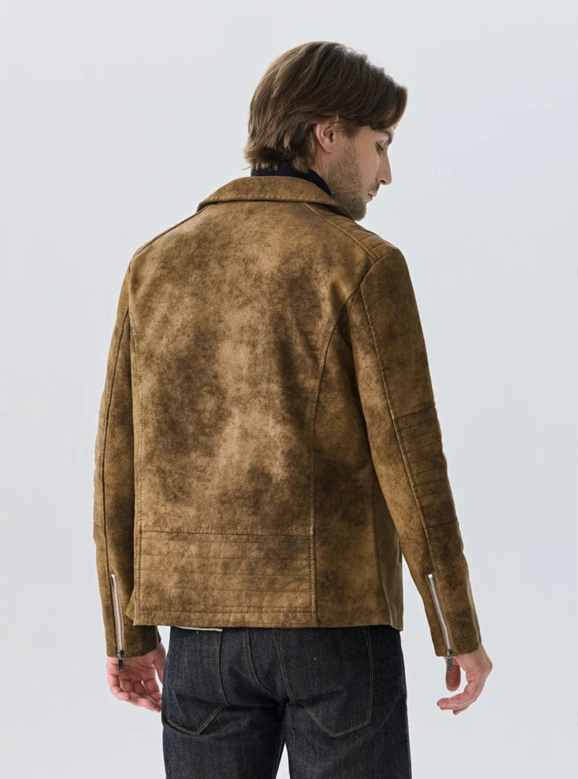 Man wearing a brown suede jacket on a light gray background