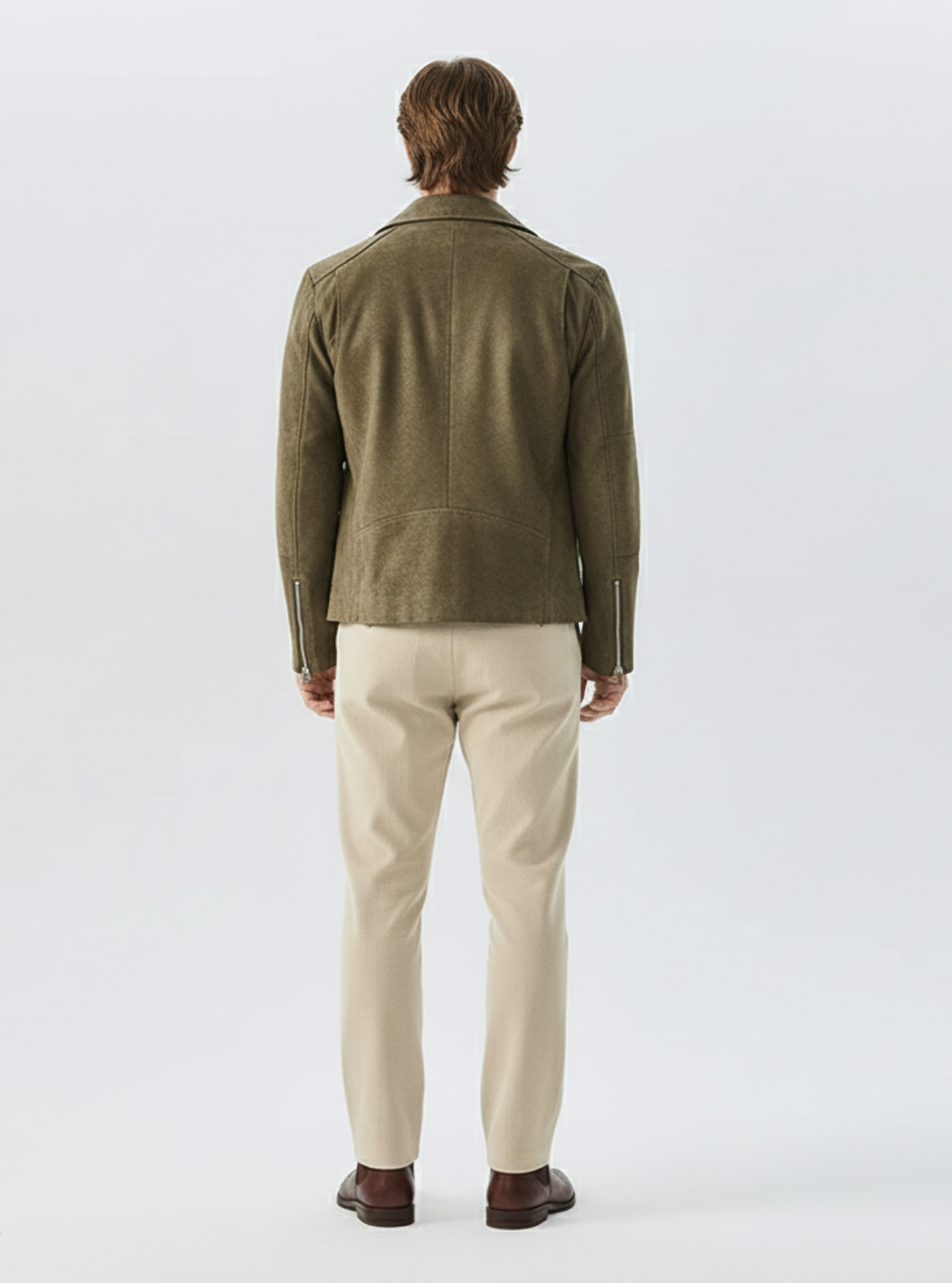 Man wearing a green jacket and beige pants on a white background