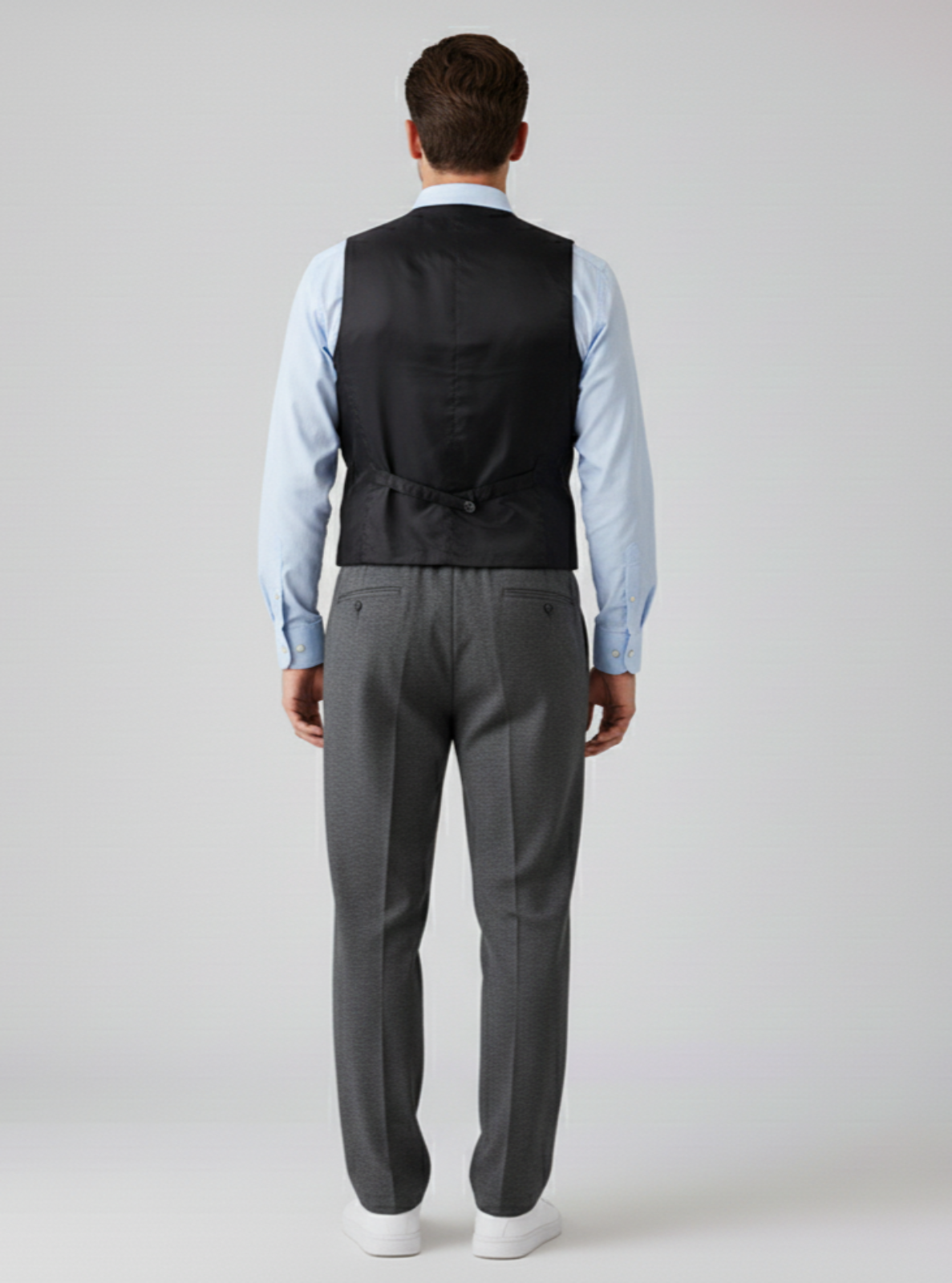 Man wearing a gray suit with a vest on a white background