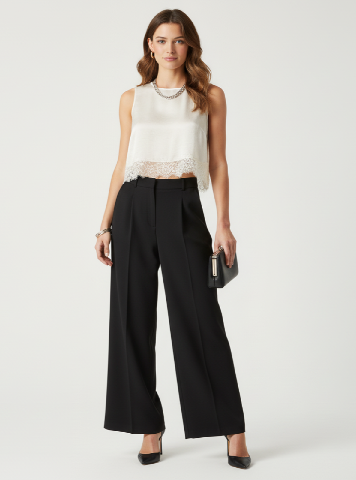 Woman wearing a white sleeveless top and black wide-leg pants on a white background